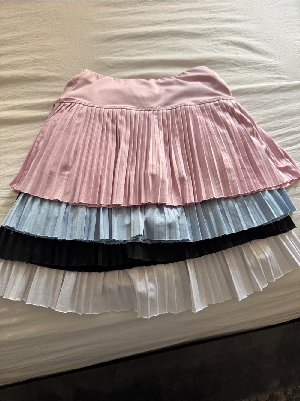 Four tween Suzette athletic girls skirts, M 8-10, pink/blue/black/white